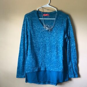 Teal sweater with necklace.